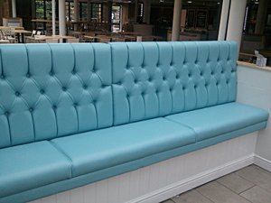 An image of blue deep buttoned seating.